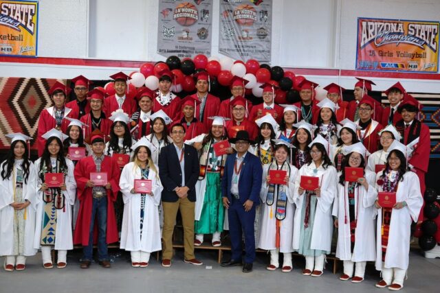 St. Michael Indian School Class of 2023, accompanied by Dr. Buu Nygren at commencement on June 3, 2023