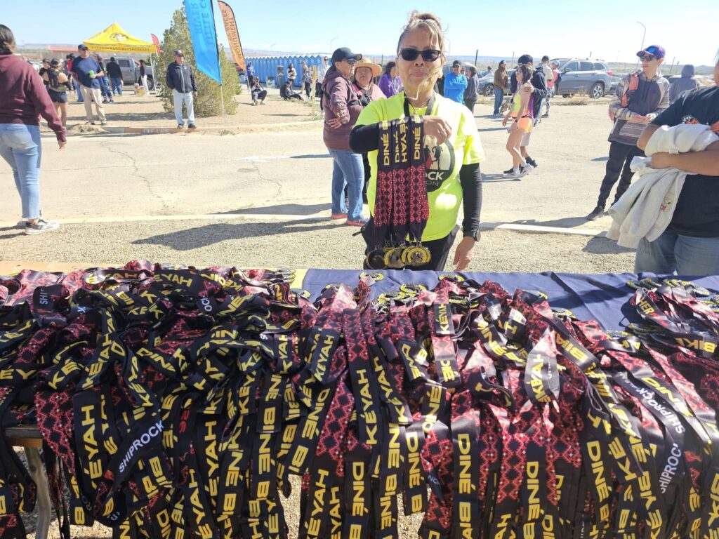 Volunteers hand out medals at the 2026 Shiprock Marathon