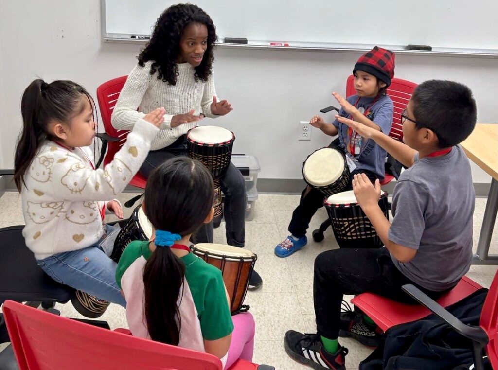 Heartbeat Music Camp students learning to play drums